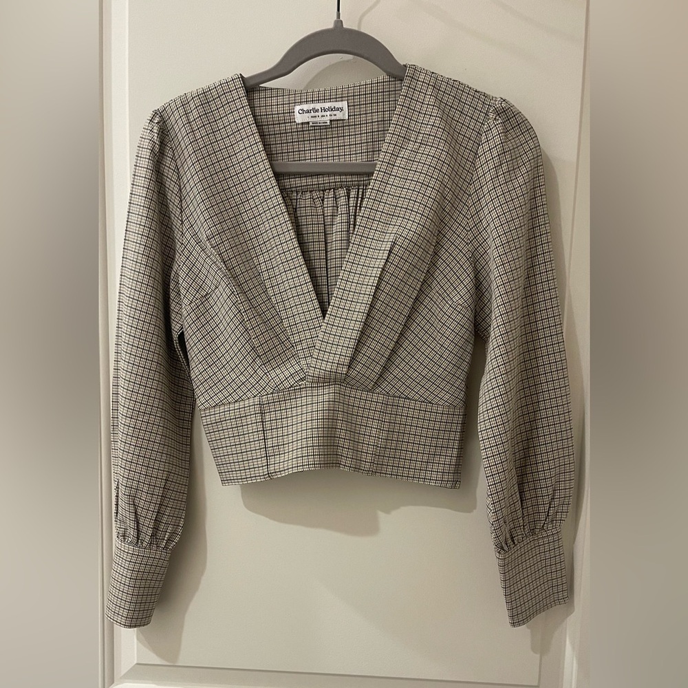 Plaid tan and black top. Cropped and low cut with an expandable back.